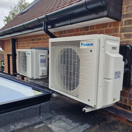 Air conditioning condensors mounted against a wall